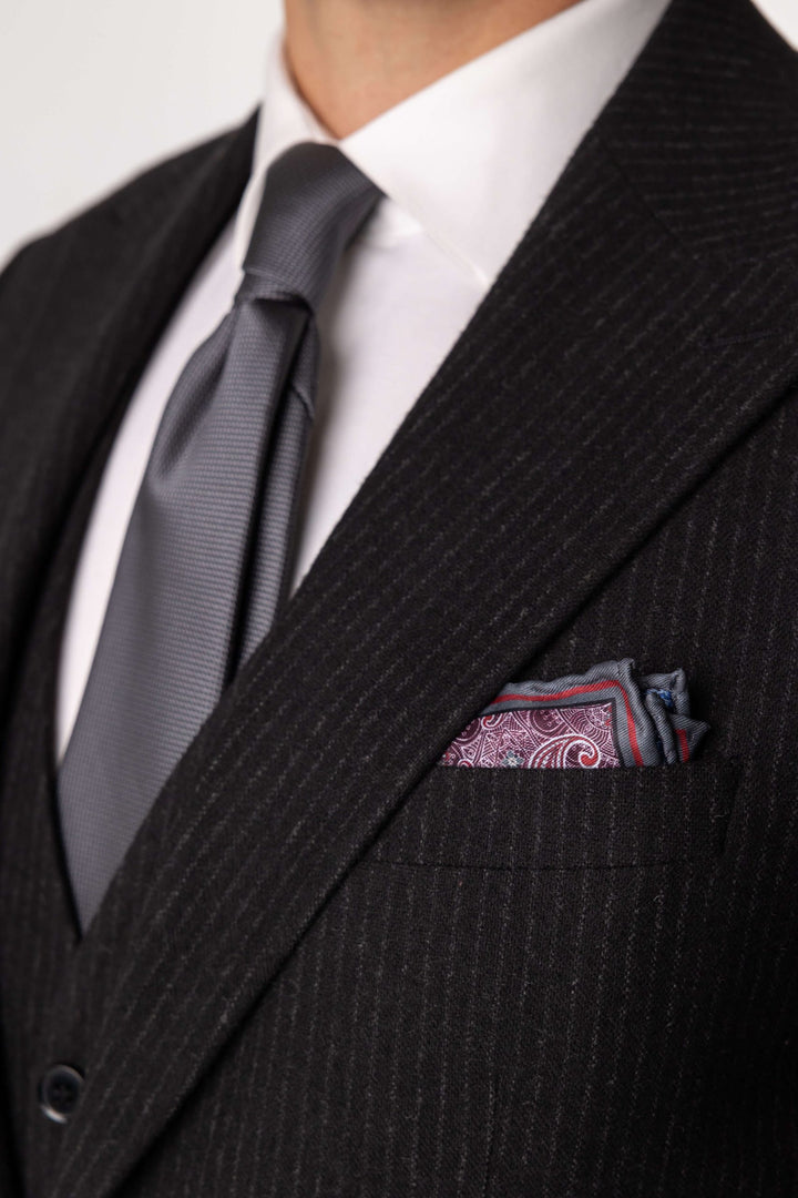 Three-piece black suit with blurred lines