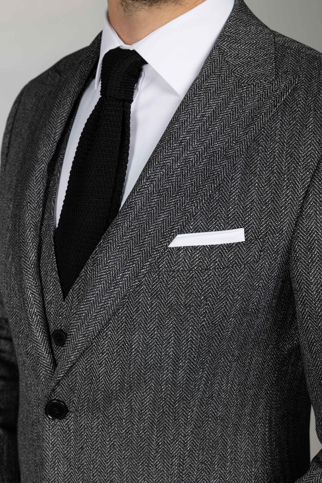 Trijų dalių pilkas kostiumas eglutės raštu
