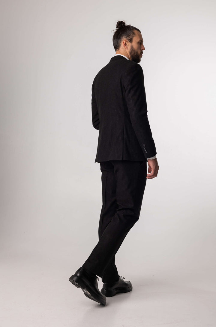 Three-piece black suit with blurred lines