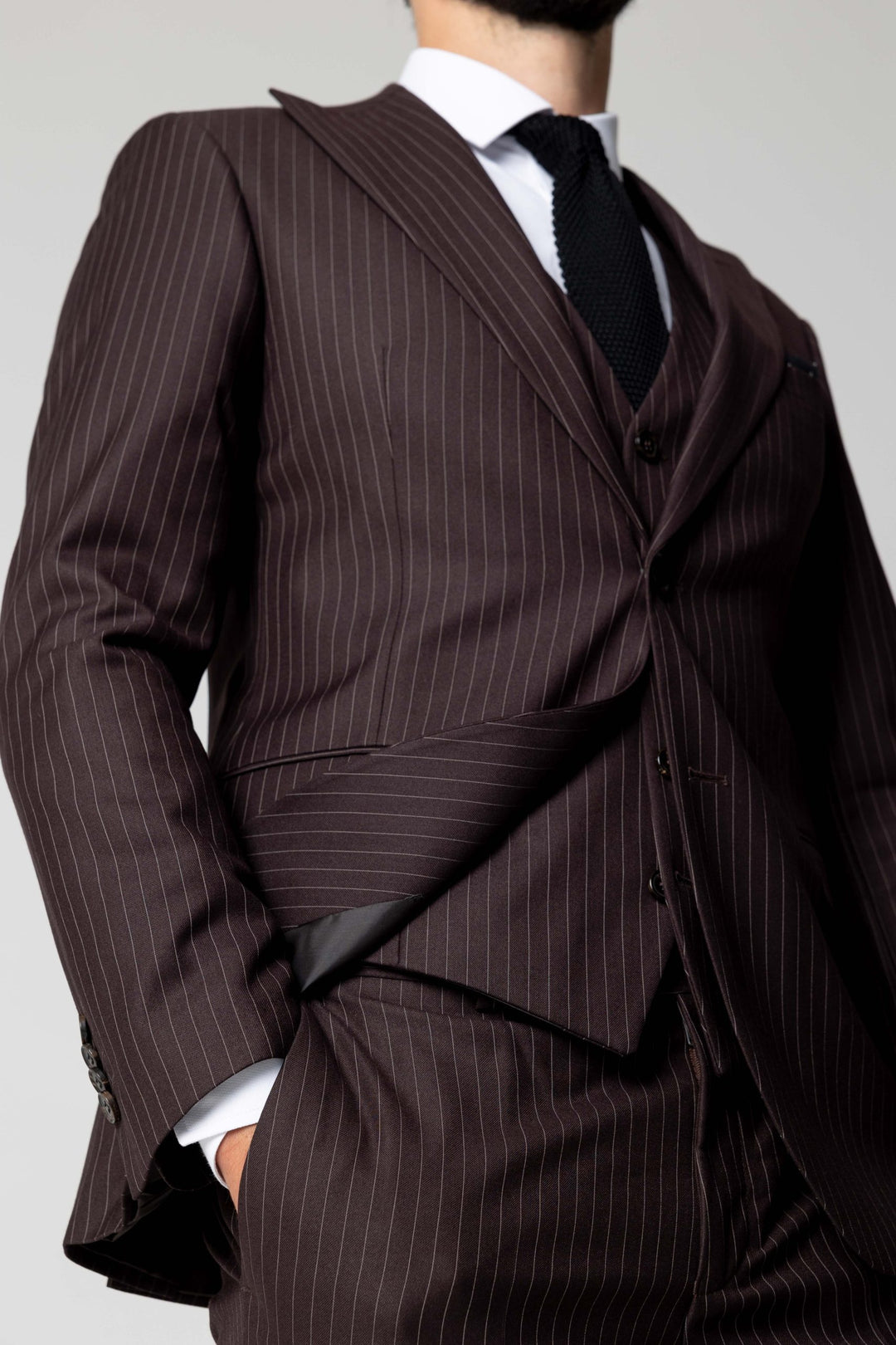 Three-piece suit in dark brown with stripes